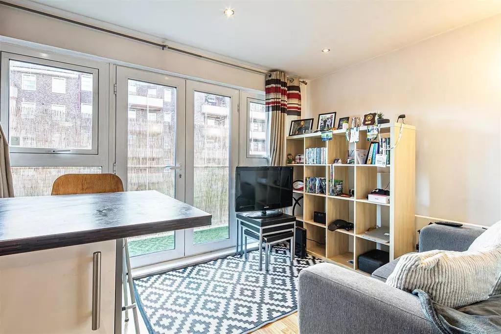 A bright and contemporary living room with larg...
