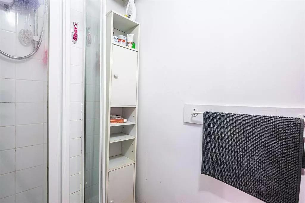 A clean and simple bathroom area with a glass s...