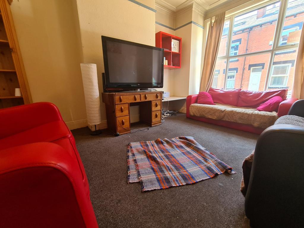 A bright, welcoming living room featuring large...