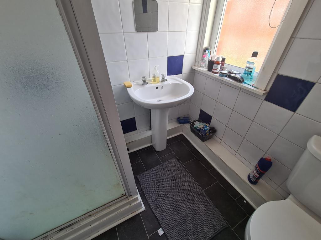 Bright and clean bathroom featuring a pedestal ...