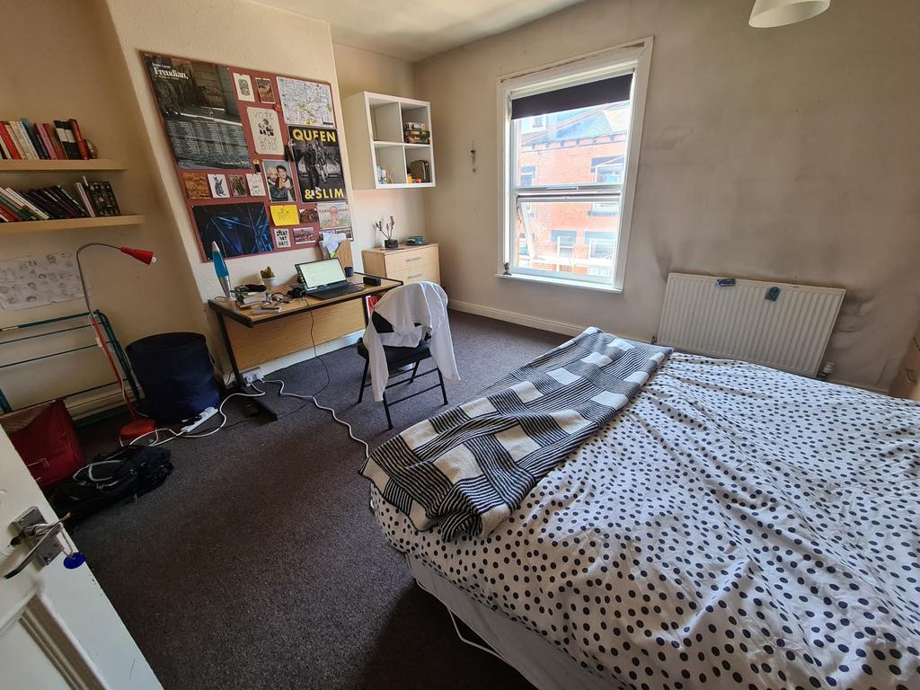 Cozy single bedroom featuring a comfortable bed...