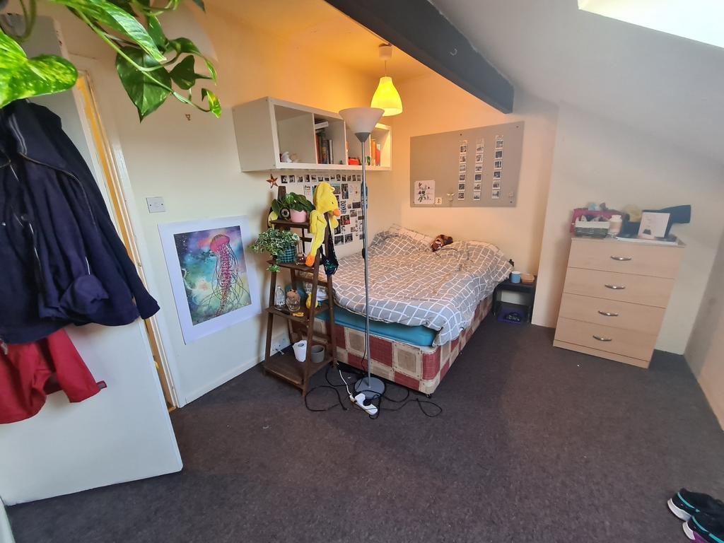 Cozy double bedroom featuring a comfortable bed...