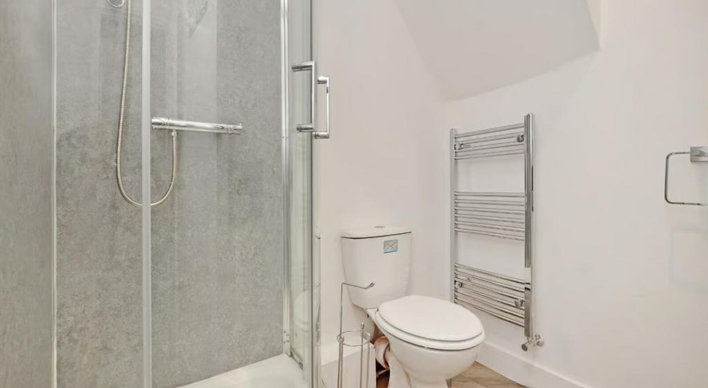 This well-appointed bathroom features a sleek s...