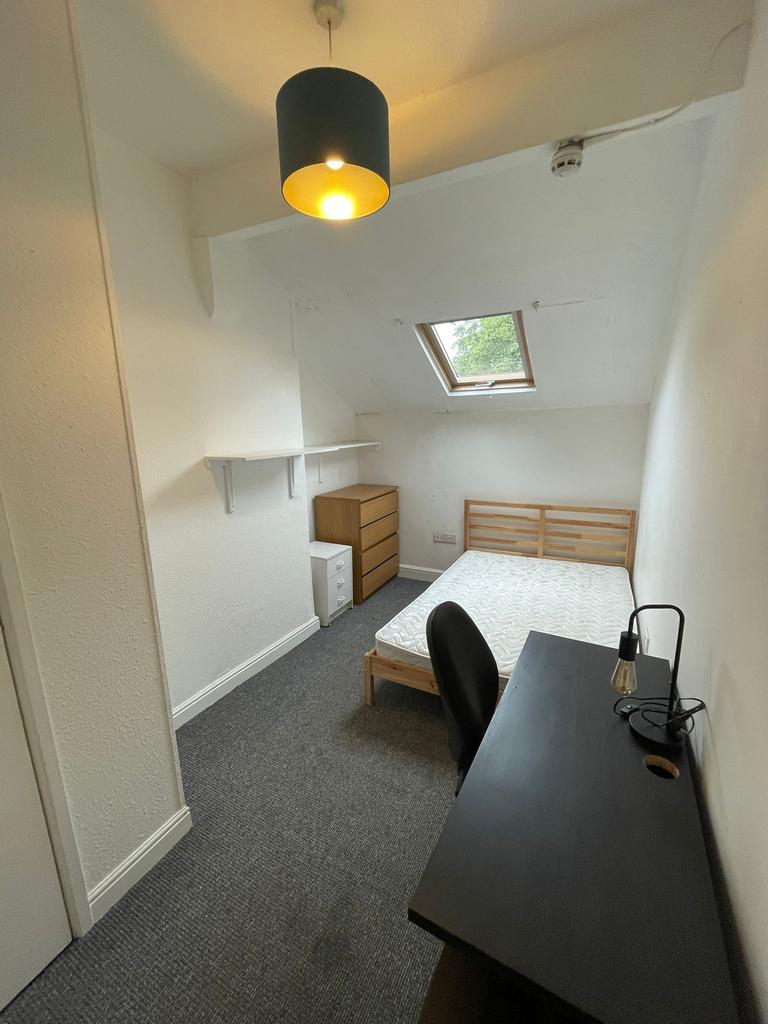 A spacious and well-lit double bedroom featurin...