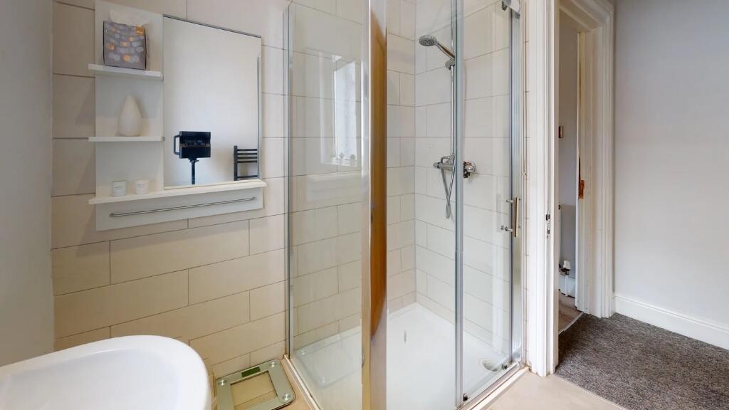 Bright and modern bathroom suite featuring a sp...