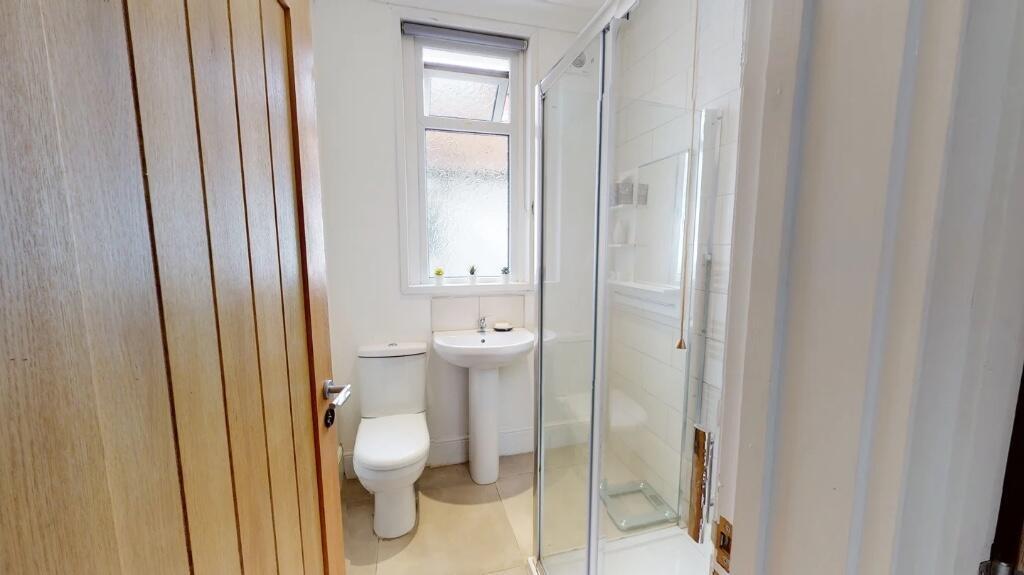 A bright and modern bathroom suite featuring a ...