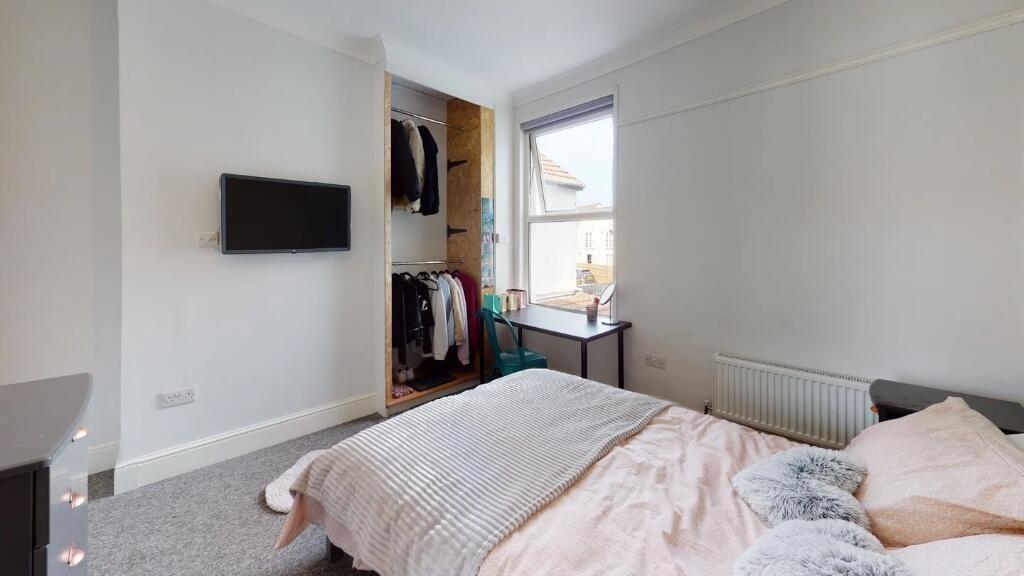 Bright and airy master bedroom featuring a comf...