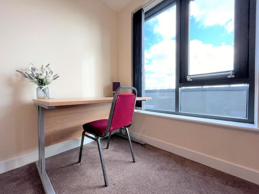 Bright and airy workspace featuring a large win...