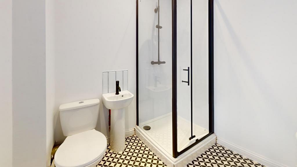 A modern and stylish bathroom featuring a sleek...