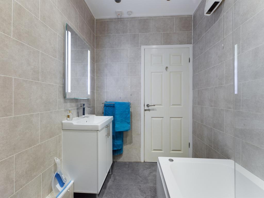 A spacious and modern bathroom featuring a styl...