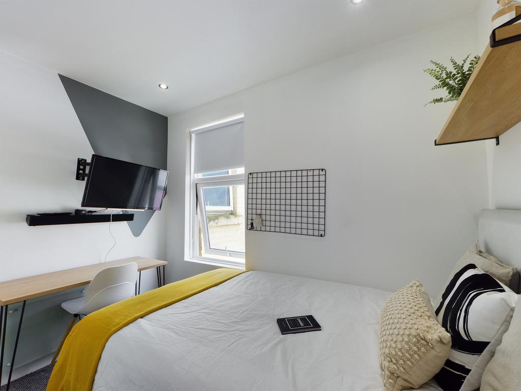 A bright and modern double bedroom featuring a ...