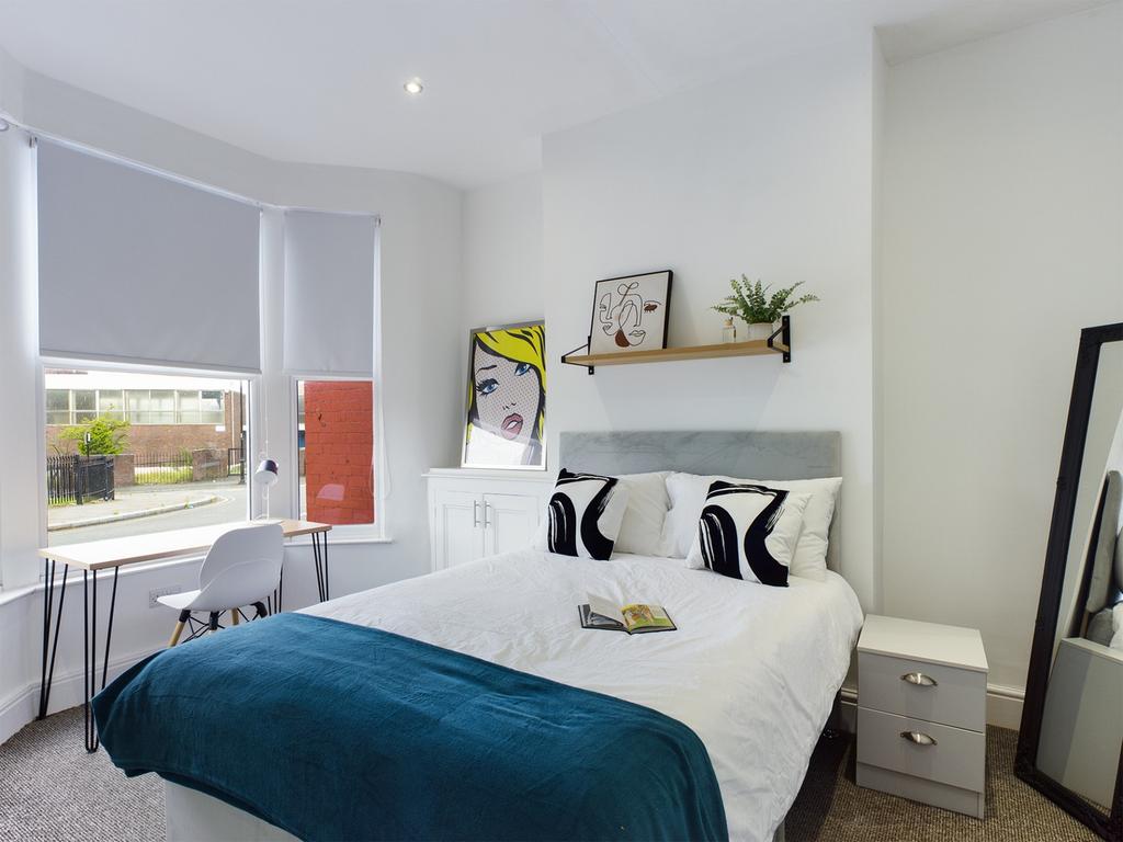 A bright and inviting double bedroom, featuring...