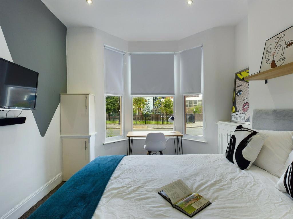 A bright and inviting double bedroom featuring ...