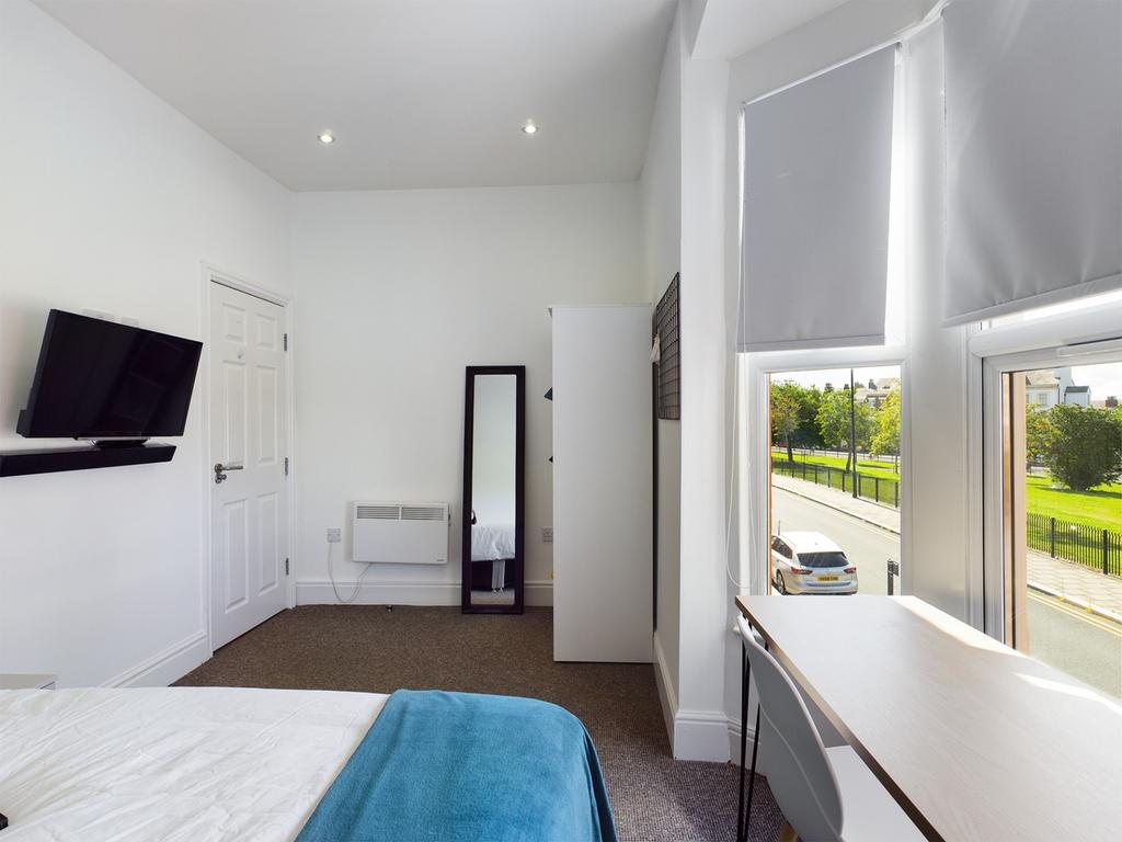 A bright and inviting double bedroom featuring ...