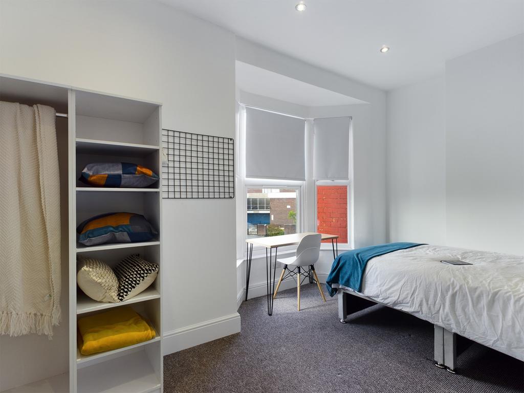 A bright and inviting double bedroom featuring ...