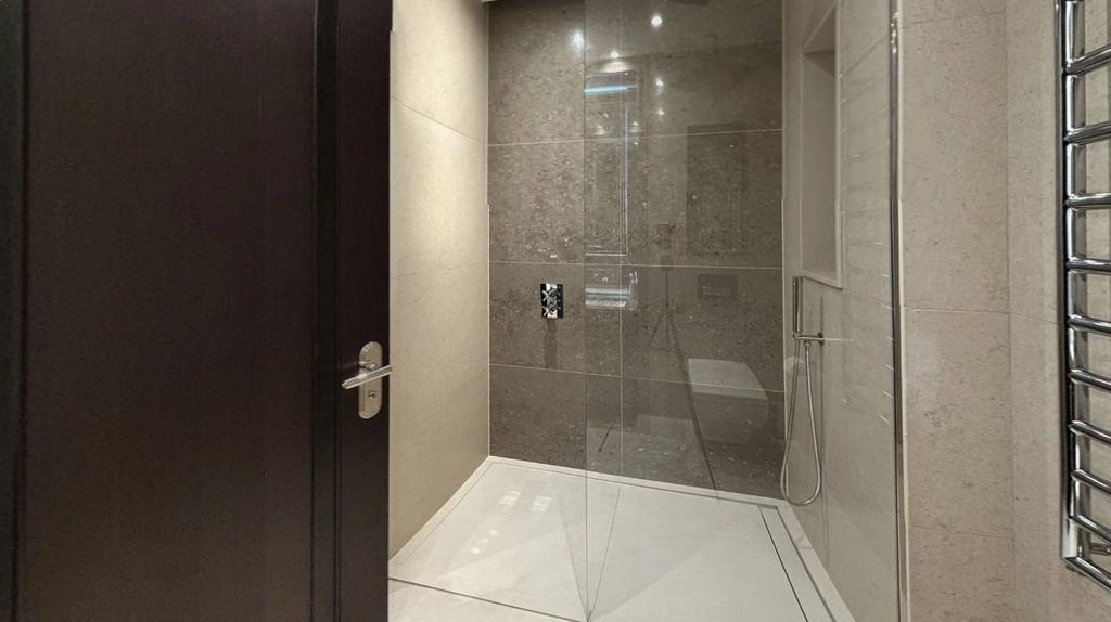 A sleek, modern bathroom suite featuring a spac...