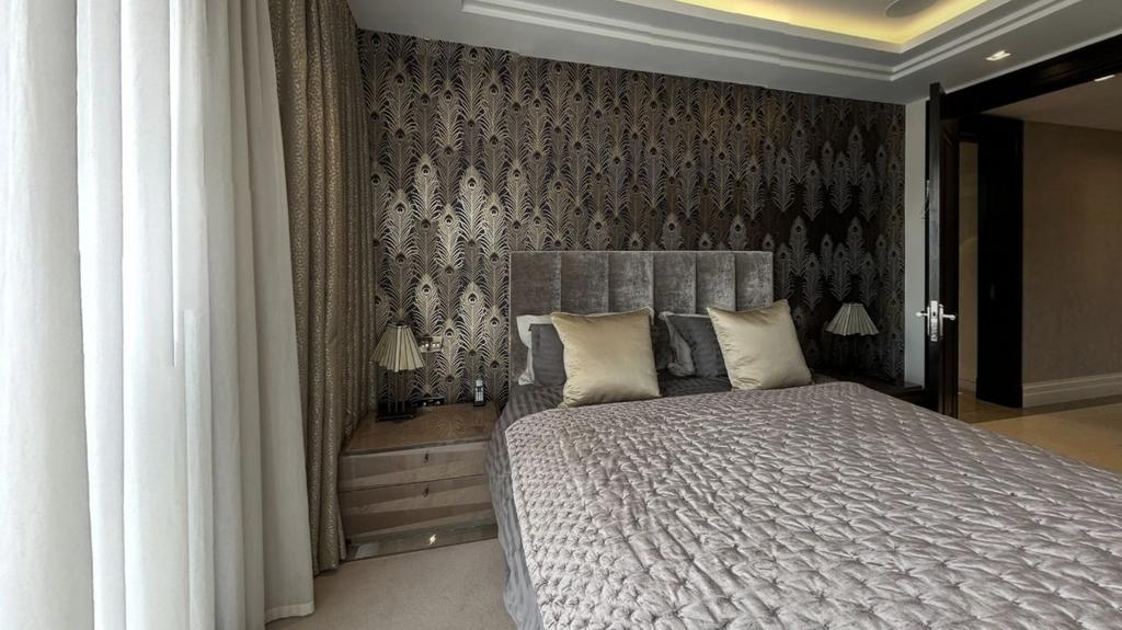 A stylish master bedroom featuring a plush doub...