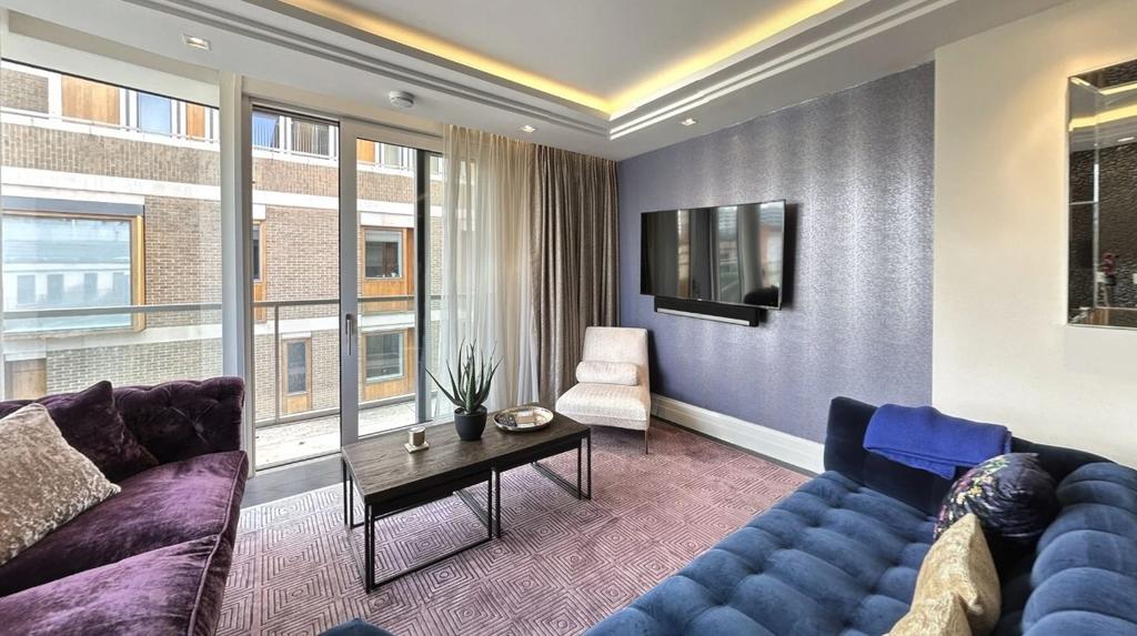 A stylish and contemporary living room featurin...