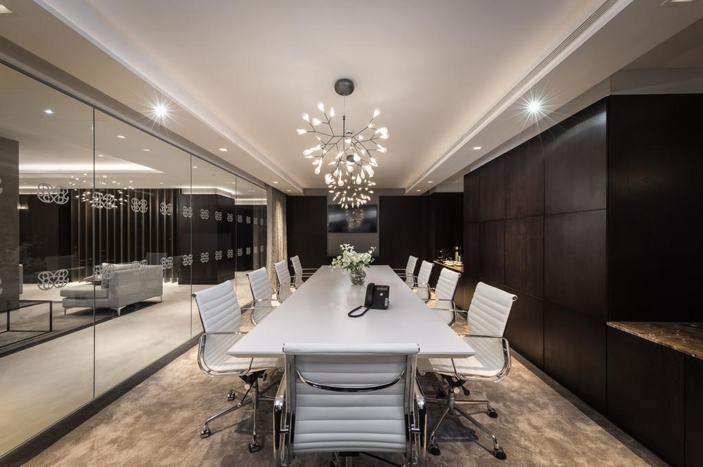 A sleek, modern communal workspace featuring a ...