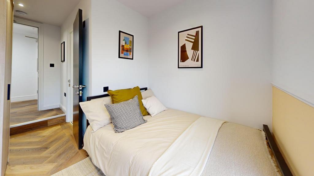 A cozy and inviting double bedroom featuring st...