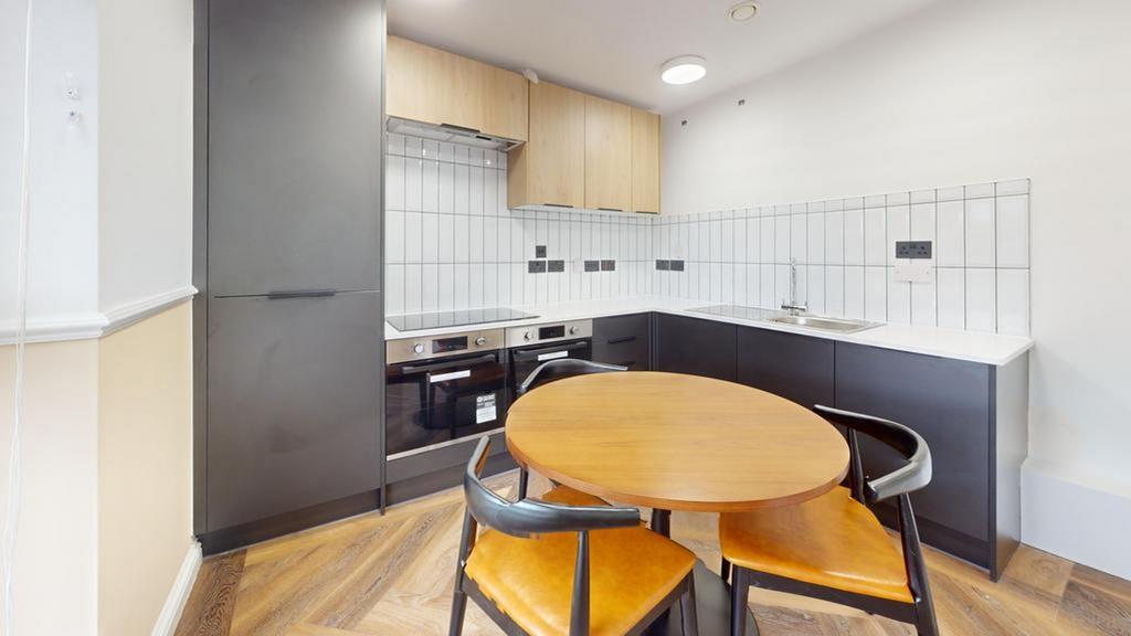A modern and tidy kitchenette featuring sleek c...