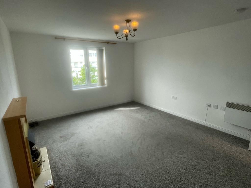 A bright and spacious living room featuring a l...