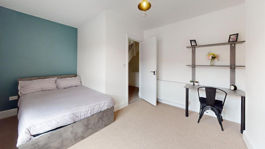 A spacious and well-lit double bedroom featurin...