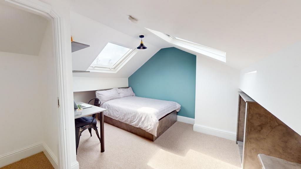 A bright and inviting double bedroom with a mod...