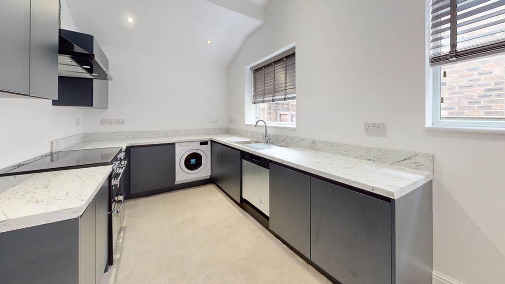 A modern and stylish kitchen featuring ample co...