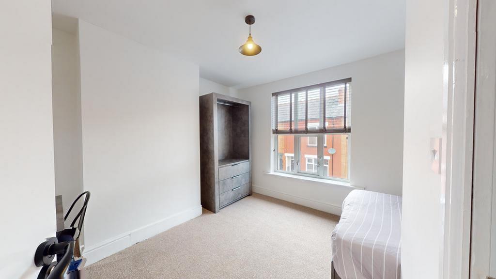 A spacious and well-lit double bedroom featurin...