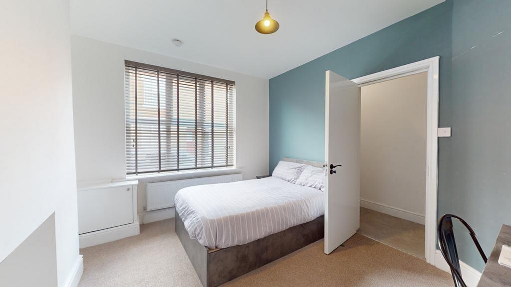 A bright and inviting double bedroom featuring ...