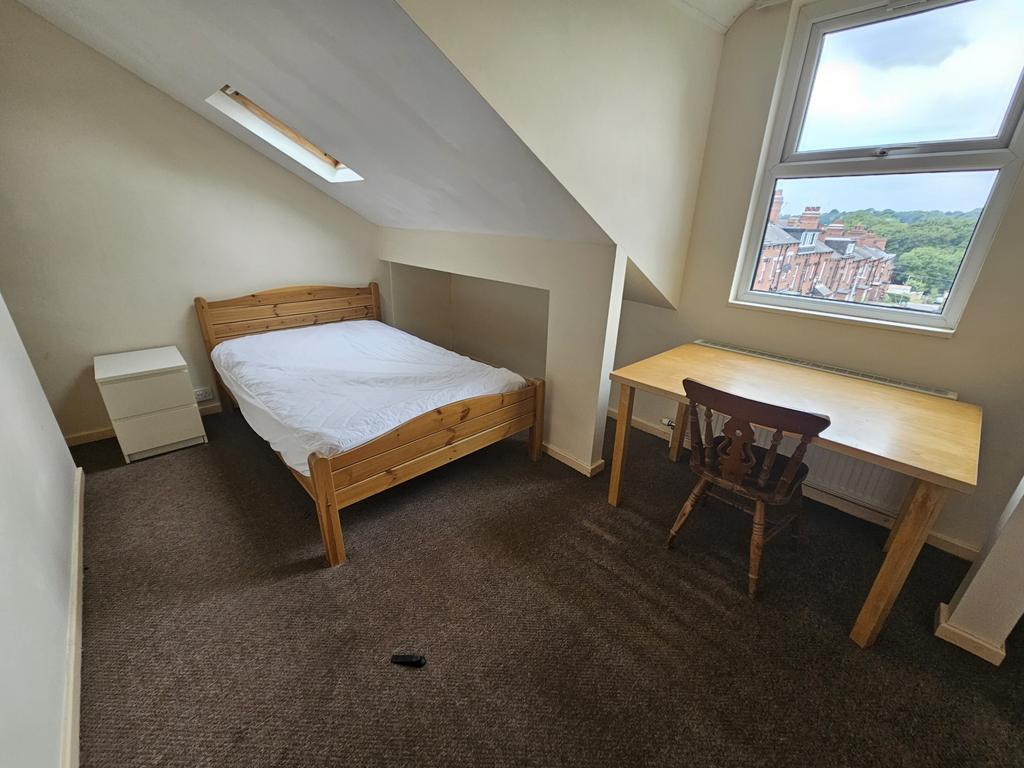 Cozy double bedroom featuring a comfortable woo...