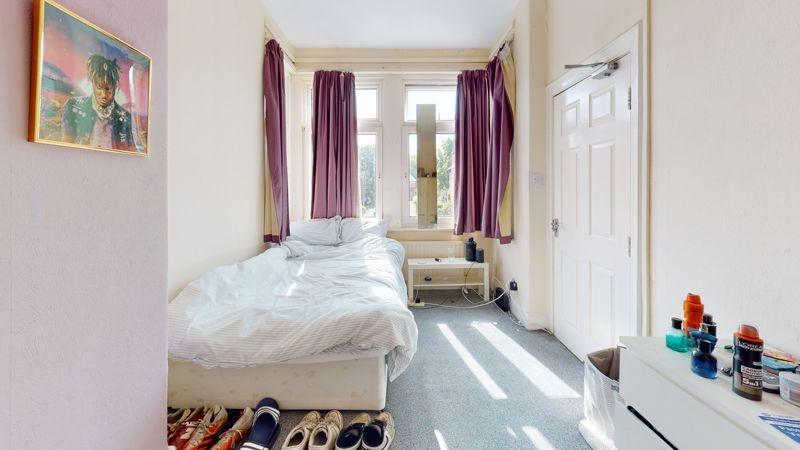 Bright and inviting bedroom with a large window...