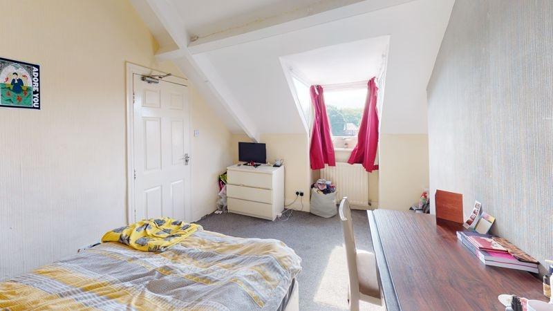 A small, clean room featuring a skylight with r...