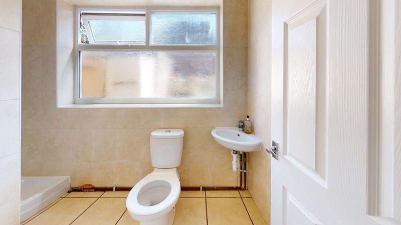 A bright and clean bathroom featuring a toilet,...
