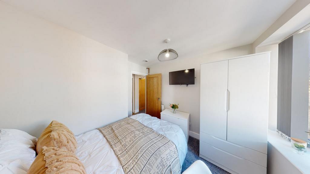 A bright and inviting double bedroom featuring ...