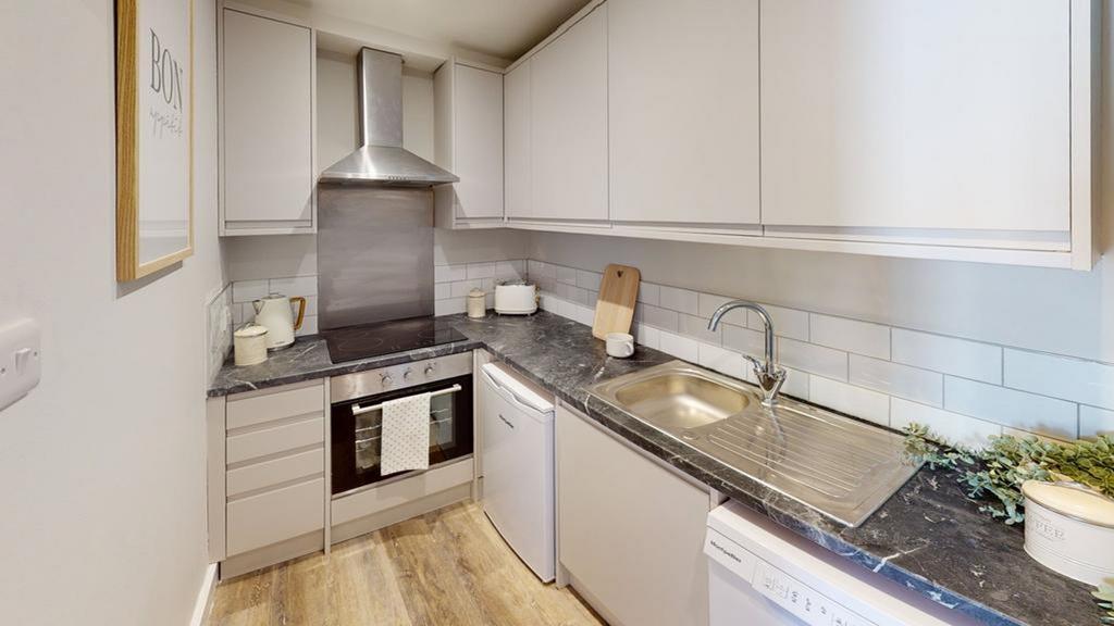 A modern and clean kitchenette equipped with es...