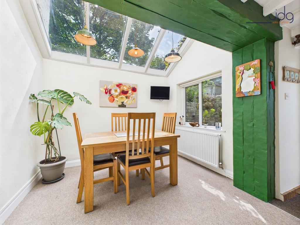 Light-filled dining area beneath a vaulted...