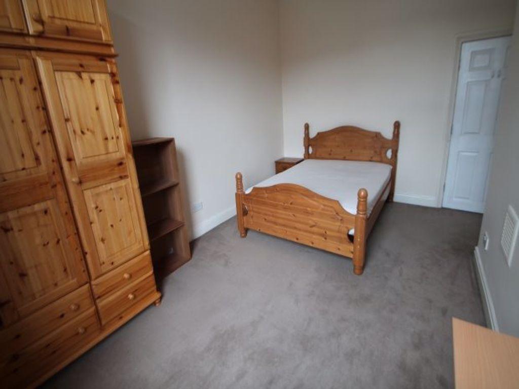 A tidy double bedroom featuring a wooden double...