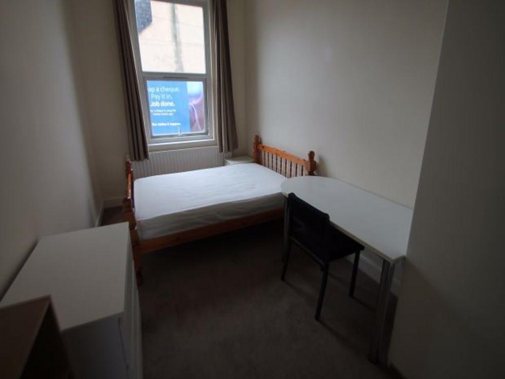 A neat and simple single bedroom featuring a wo...