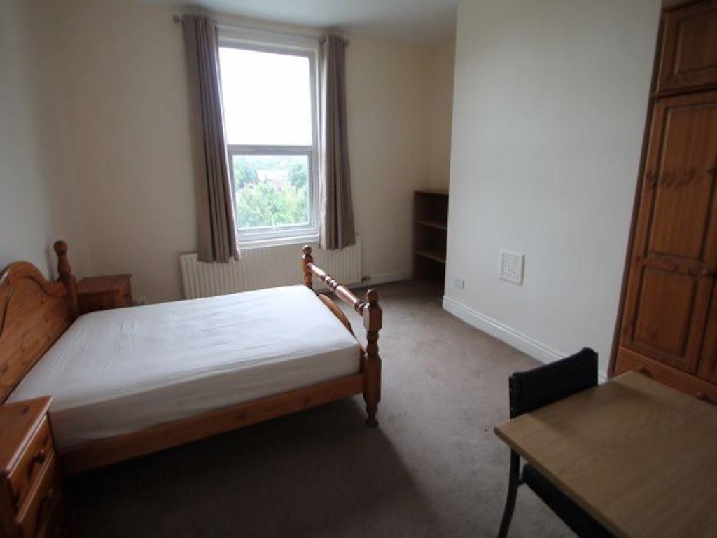 A simple and tidy double bedroom featuring a wo...