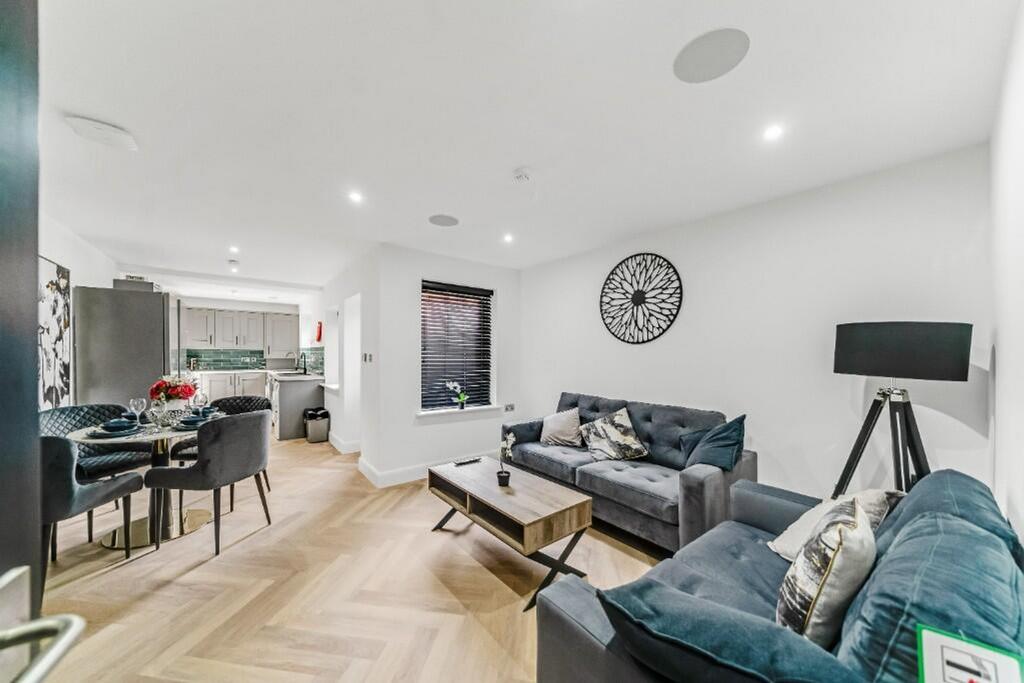 A stylish and contemporary living room featurin...