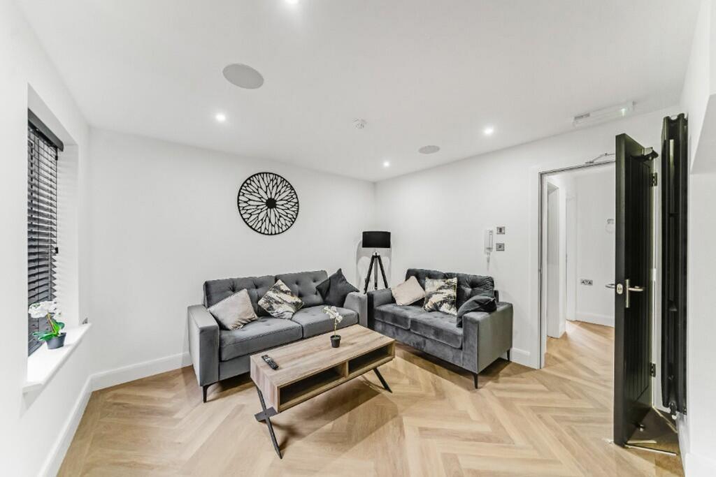 A stylish and contemporary living room featurin...