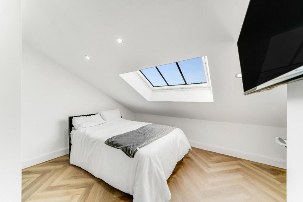 Bright and airy double bedroom featuring a larg...