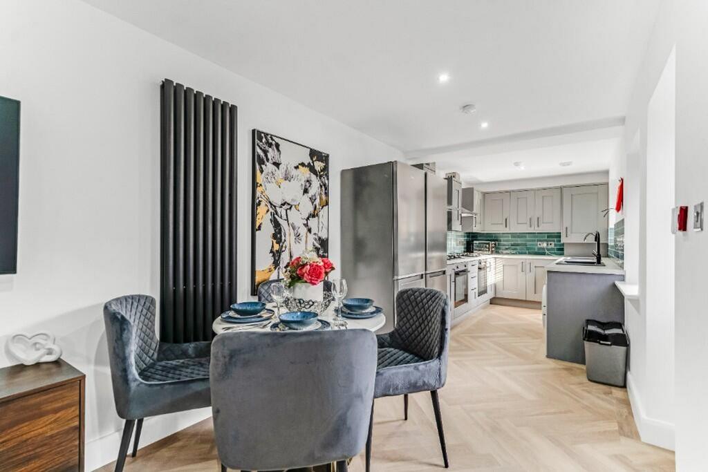 A stylish kitchen featuring modern appliances, ...