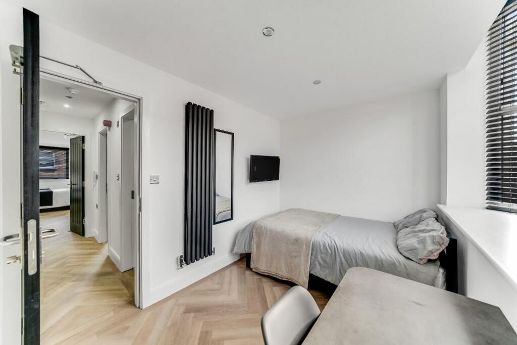 A bright and spacious double bedroom featuring ...