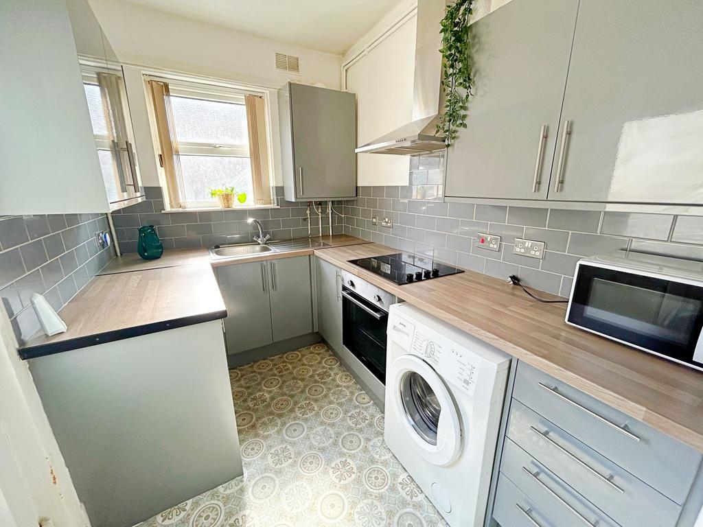 Bright and modern kitchen featuring sleek gray ...