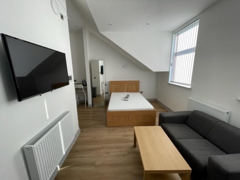 Bright and modern master bedroom featuring a co...