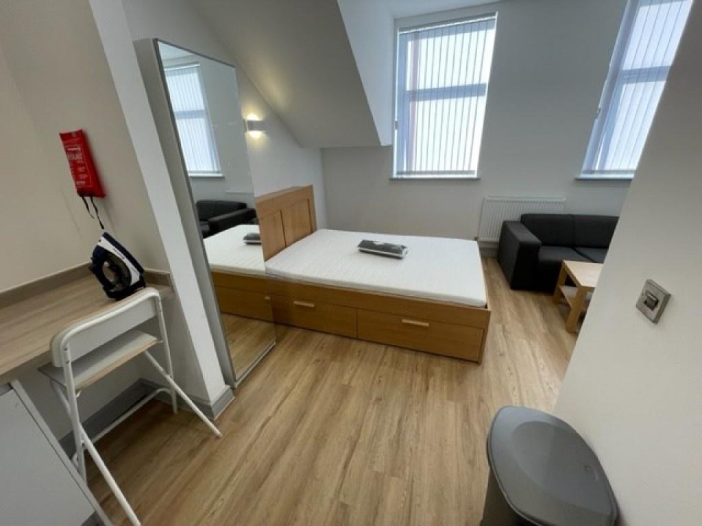 A bright and tidy double bedroom featuring a wo...