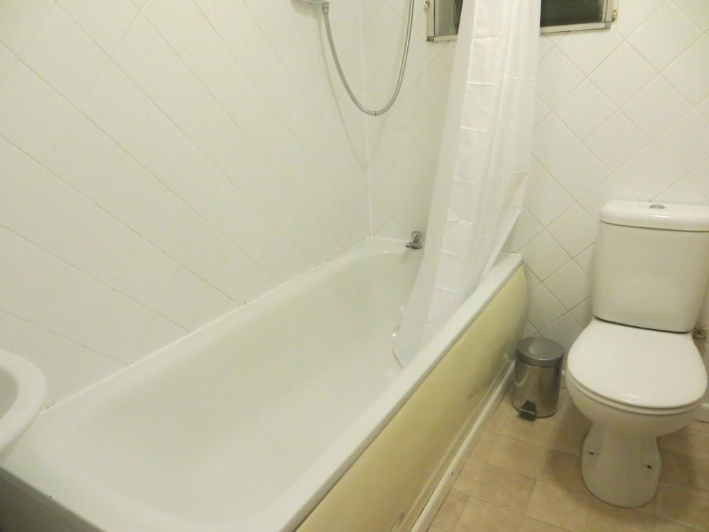 A clean and functional bathroom suite featuring...